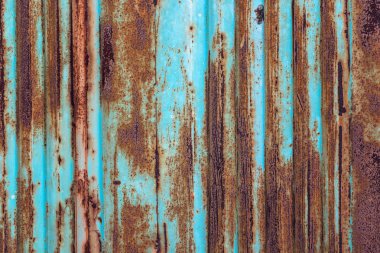 Rusty metal background with old layers of blue paint. Texture ru clipart