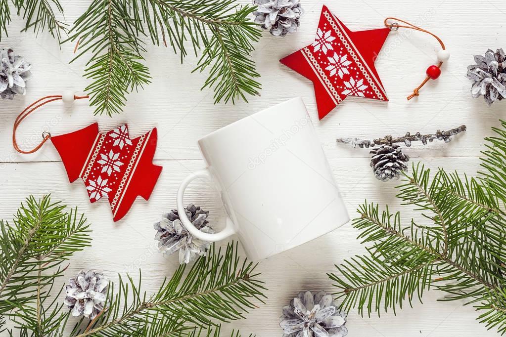 White coffee mug with Christmas decorations and fir branches. Sp