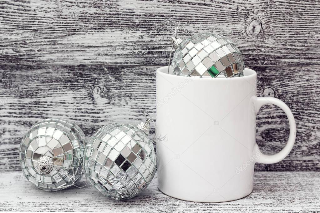 White coffee mug with Christmas decorations - mirror balls . Spa