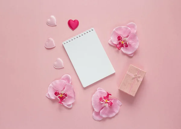 Ανοίξτε το σημειωματάριο με κιβώτιο δώρων, orchid λουλούδια και καρδιές σε κενό — Φωτογραφία Αρχείου
