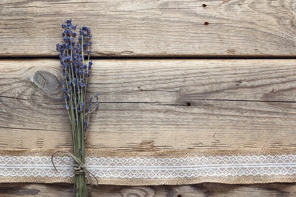 Lavender flowers bouquet on rustic wooden background.