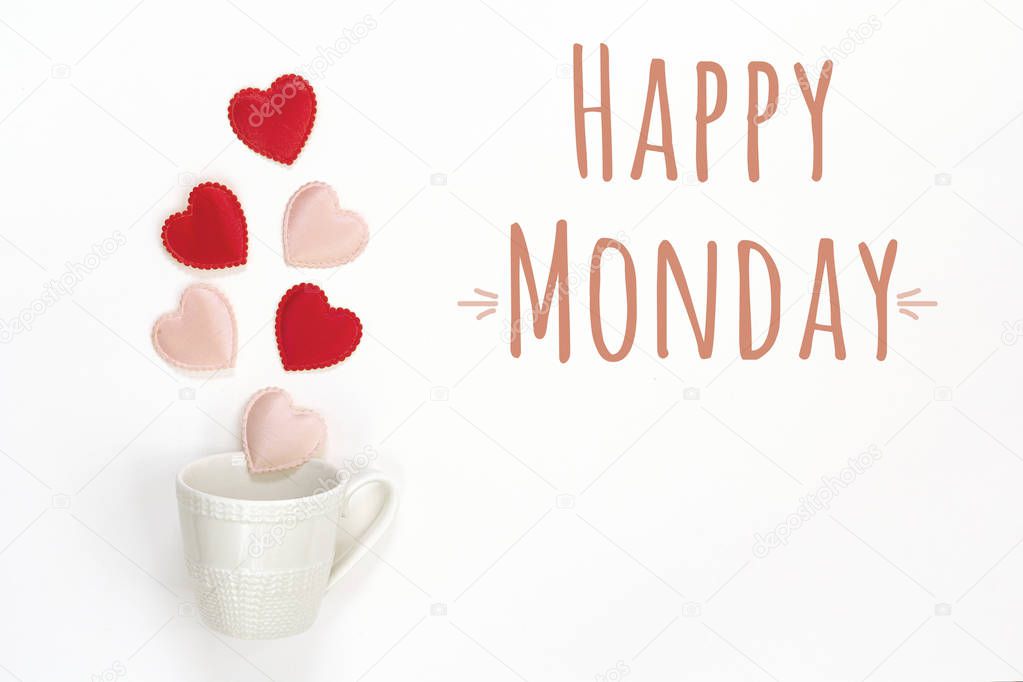 Happy Monday message and coffee cup with hearts coming out of it