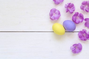 Paskalya yumurtaları sarı ve mor ve beyaz woode mor çiçekler