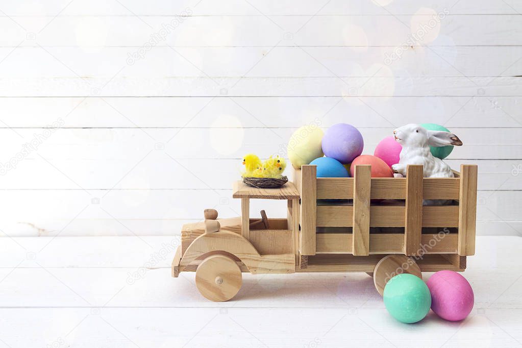 Wooden toy truck with Easter eggs and a rabbit in the back.  Spa