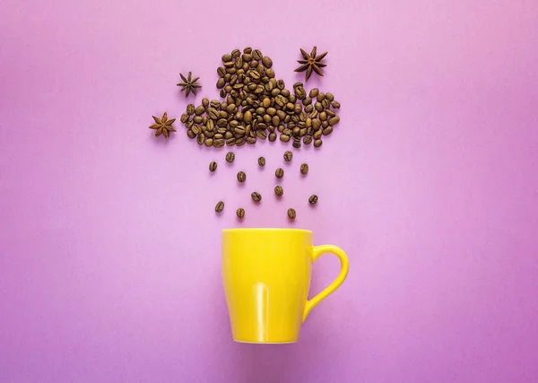 Coffee beans in shape of rainy cloud with yellow mug on purpleba — Stock Photo, Image