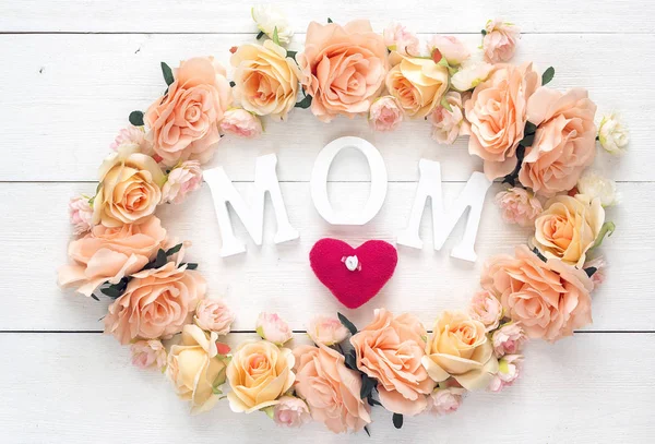 Mothers day background with pink roses on a white table. Happy m