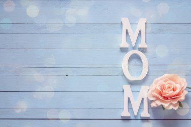 Gül çiçek mavi ahşap bir masa ile anneler günü mesajı. PLA