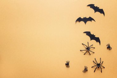 Dekoratif örümcekler ve yarasalar alan turuncu zemin üzerine 
