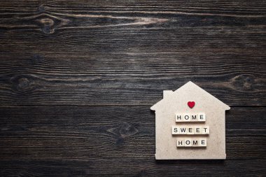 Teklif ve kalp şeklinde ahşap zemin üzerine ev sembolü