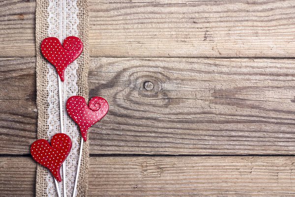 Rustic wooden background with sacking border and hearts. Copy sp
