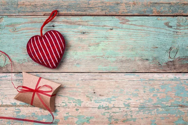 Confezione regalo con cuore su vecchio sfondo in legno turchese. Spazio per — Foto Stock