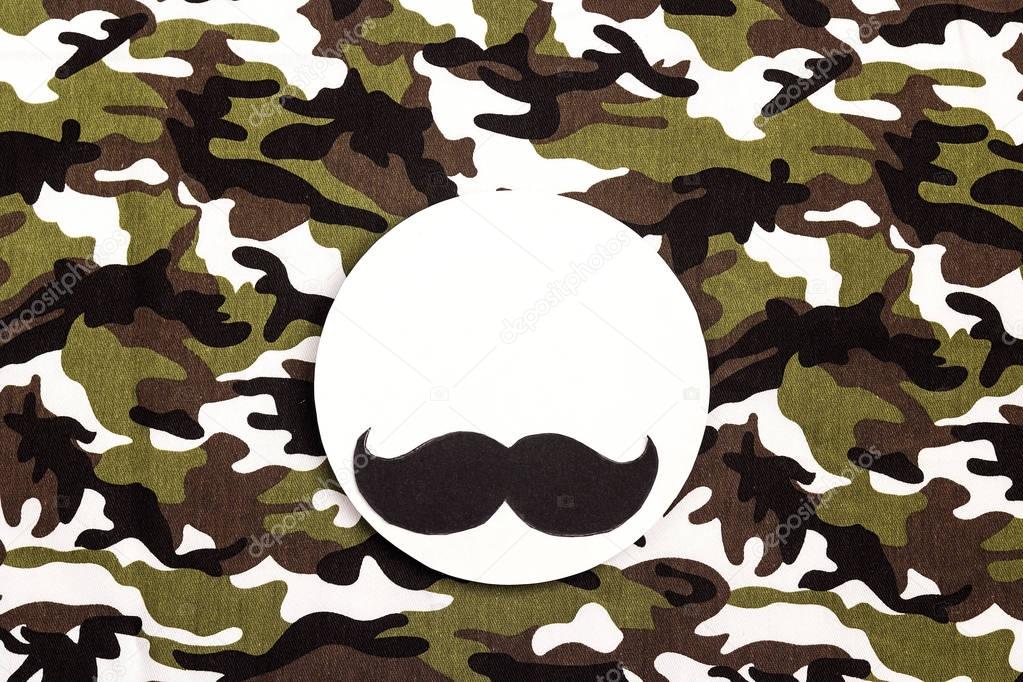 White round frame with mustache on military camouflage backgroun