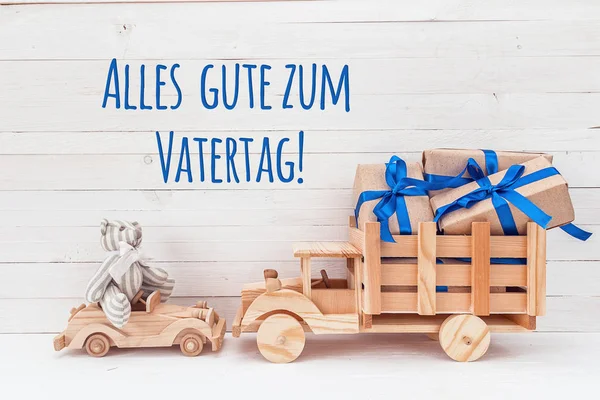 Wooden car with teddy bear and wooden truck with gifts. German g