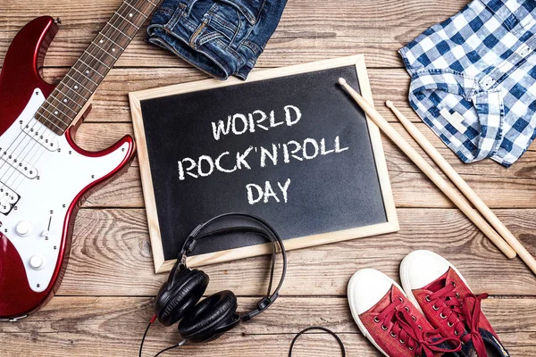 World Rock'n'Roll Day background with blackboard, music equipmen — Stock Photo, Image