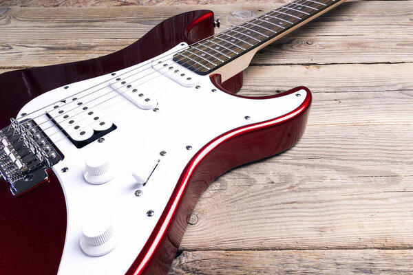 Electric guitar on wooden table. Musical concept.