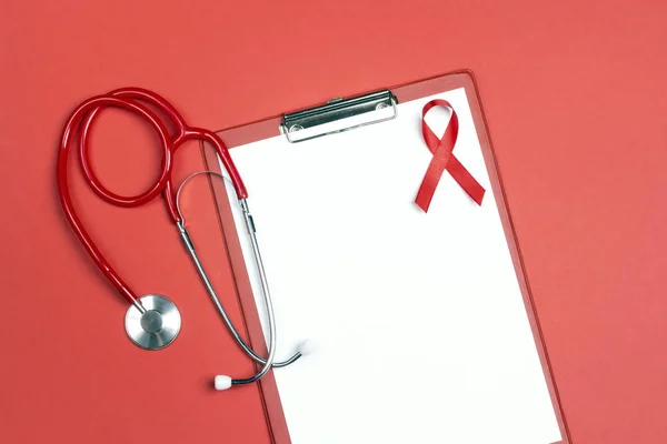 Empty medical folder with red ribbon as symbol of aids awareness