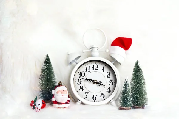 Alarm clock with little santa and christmas decorations on white — Stock Photo, Image