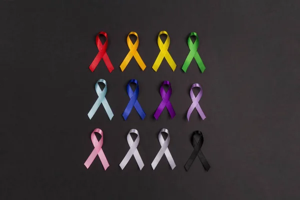 Colorful awareness ribbons on black background. World cancer day — 스톡 사진