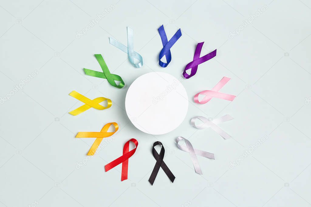 Circle of  colorful awareness ribbons with place for text on blu