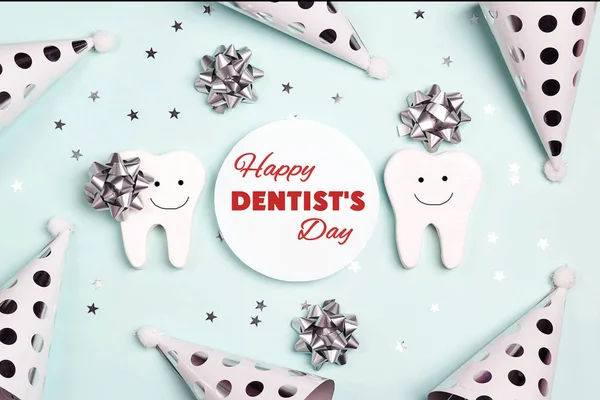 Happy Dentist\'s Day greeting card with teeth and holiday caps on