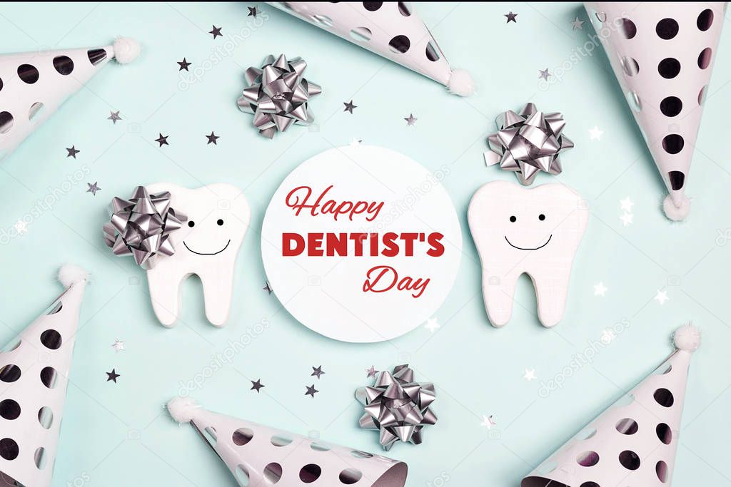 Happy Dentist's Day greeting card with teeth and holiday caps on