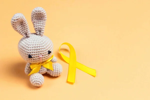 Children's toy with a Childhood Cancer Awareness Golden Ribbon o — 스톡 사진