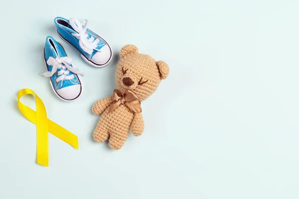 Childhood Cancer Awareness Yellow Ribbon with toy bear and baby — 스톡 사진