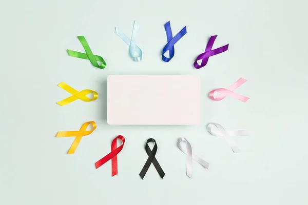 Colorful awareness ribbons with place for text on blue backgroun — Stock Photo, Image