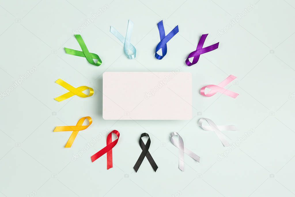 Colorful awareness ribbons with place for text on blue backgroun