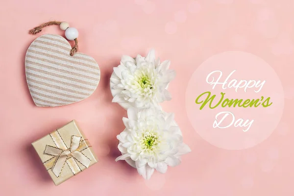 International Women\'s Day background with gift, heart and chrysanthemum flowers  in the form of eight. March 8.