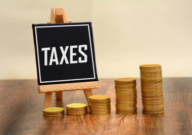 Altın sikke yığını ile tebeşir tahtada yazılı vergi