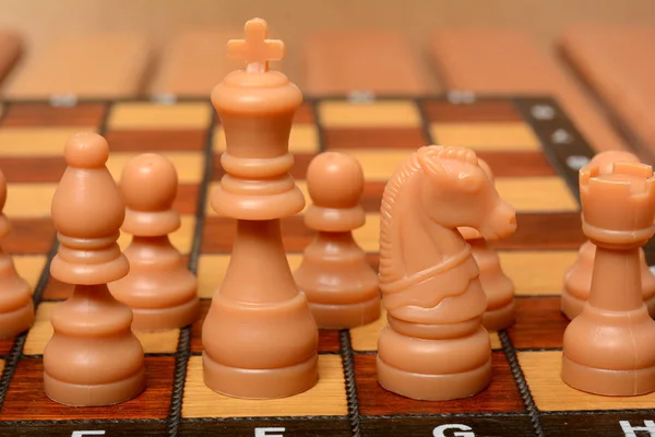 Chess with King figure in the center with other pawns