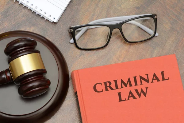 Criminal Law sign with wooden gavel and red book