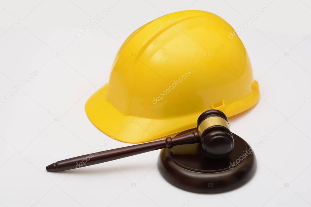 Labor Law with safety helmet and gavel