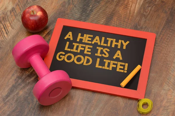 A Healthy Life is a good one chalkboard with dumbbell sign — Stock Photo, Image