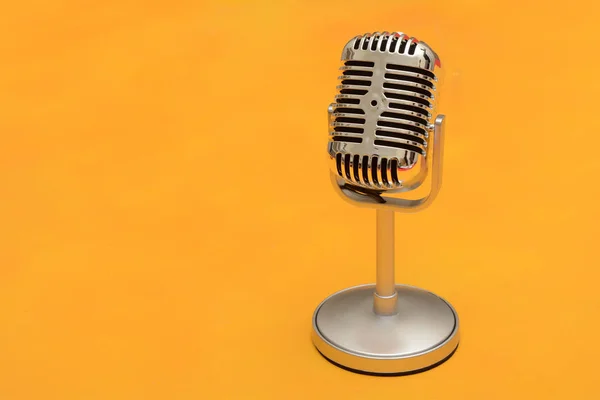 Redtro style metal microphone on yellow background — Stock Photo, Image