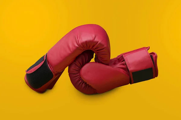 Pair of red leather boxing gloves isolated on red background with copy space — Stock Photo, Image