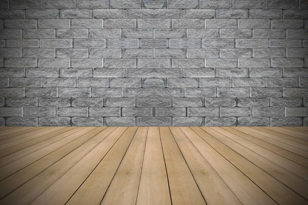 Деревянный пол и каменная стена — стоковое фото