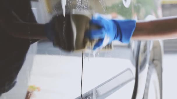 Car Wash Staff Wearing Blue Rubber Gloves Using Sponge Moistened — Stock Video