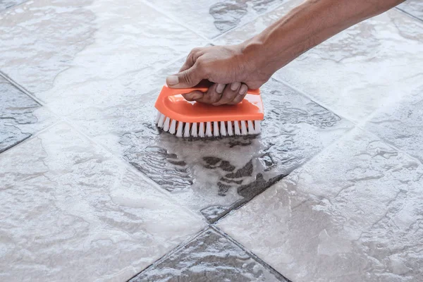 Cleaning the tile floor.