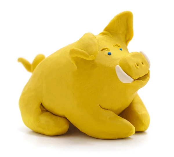 Yellow plasticine pig isolated on white background.