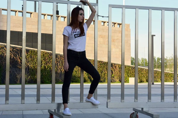 Young model posing next to the fence — Stock Photo, Image