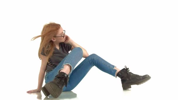 Beautiful red-haired girl with glasses on a white background — Stock Video