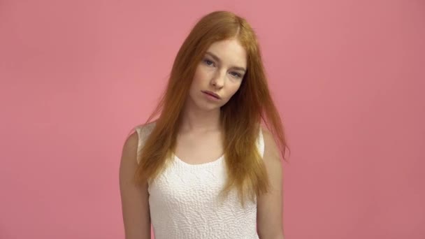 Portrait red-haired fashion model in pink dress on a pink background — Stock Video
