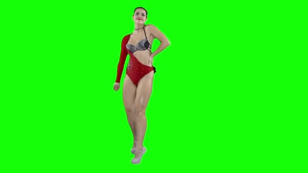 A girl in a red swimsuit is dancing, on a green screen — Stock Video