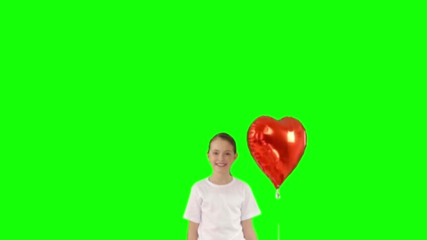 Ragazzina in possesso di fascio di palloncini d'aria a forma di cuore rosso isolato sullo schermo verde. Tiro al rallentatore — Video Stock