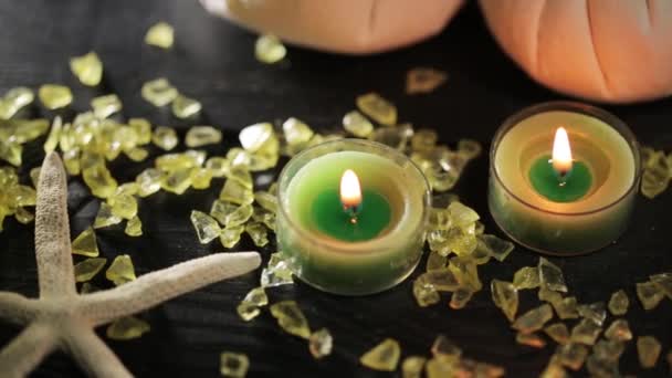 Зеленые свечи в спа-салоне и массажное масло — стоковое видео