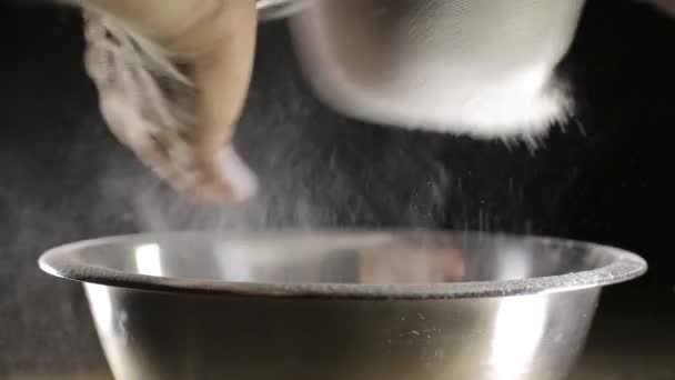 A man sifts the flour through a sieve — Stock Video