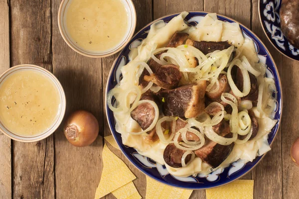 Nationale schotel van Kazachs - Beshbarmak en bouillon in de kommen — Stockfoto