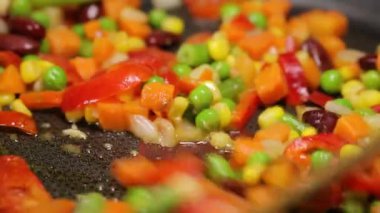 Bir kızartma tavası yakın çekim üzerinde renkli kızarmış sebze.